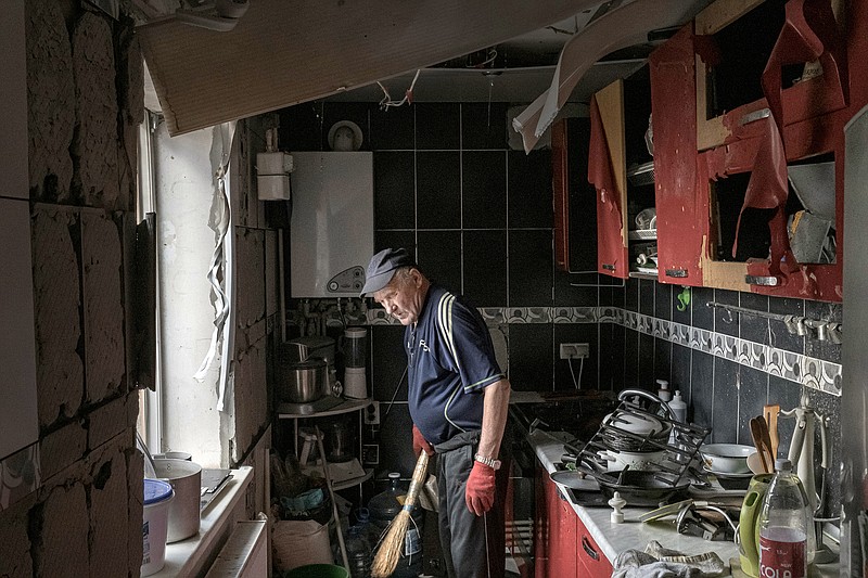 A man begins cleaning debris out of his kitchen Friday in Bakhmut in eastern Ukraine after a Russian artillery attack the night before.
(The New York Times/Mauricio Lima)