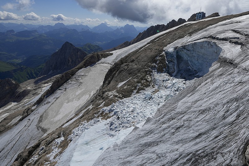 FILE - A view taken from a rescue helicopter of the Punta Rocca glacier near Canazei, in the Italian Alps in northern Italy, Tuesday, July 5, 2022, two days after a huge chunk of the glacier broke loose, sending an avalanche of ice, snow, and rocks onto hikers. Italian authorities on Saturday, July 9, 2022 put the final death toll of an avalanche in northern Italy at 11 and said all the victims had been identified nearly a week after a chunk of ice detached from a melting glacier and sent a torrent of ice, rock and debris on hikers below.  (AP Photo/Luca Bruno, File)