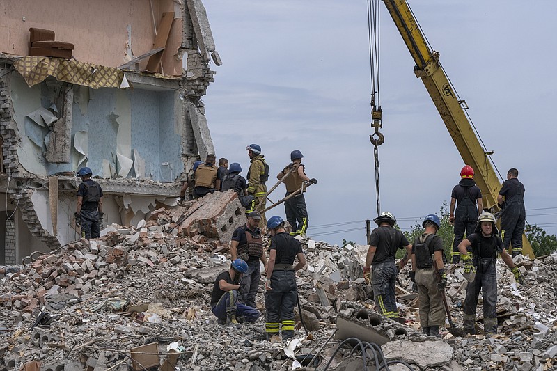 The Associated Press
Rescue workers sift through rubble in the aftermath of a Russian rocket that hit an apartment residential block, in Chasiv Yar, Donetsk region, eastern Ukraine, Sunday.