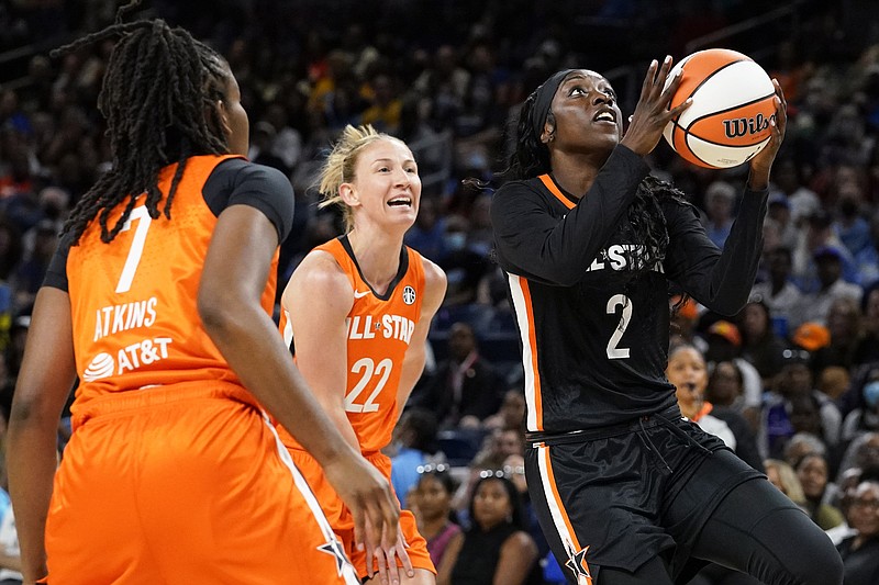 Team Stewart's Kahleah Copper, right, drives to the basket past Team Wilson's Ariel Atkins, left, and Courtney Vandersloot during the first half of a WNBA All-Star basketball game in Chicago, Sunday, July 10, 2022. (AP Photo/Nam Y. Huh)