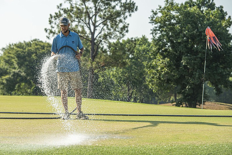 Jon Obermark, assistant superintendent, waters a green on Friday, July 15, 2022, at the Ben Geren Golf Course in Fort Smith. Paul Wanstreet, marketer and pro shop manager for the golf course, told the Sebastian County Parks Advisory Board at its meeting Monday that the course took in $441,602 in total revenue this year as of June 30, a 9.3% increase from January through June 2021. Go to nwaonline.com/220717Daily/ for today's photo gallery.
(NWA Democrat-Gazette/Hank Layton)