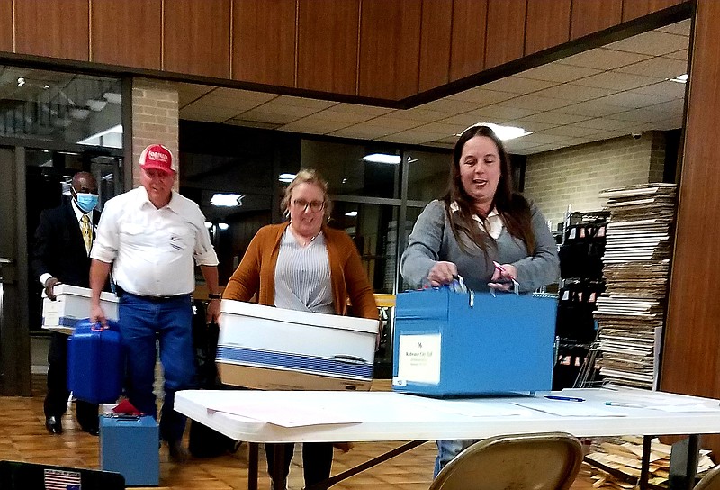 Election workers deliver ballot boxes to the Bowie County Courthouse on Tuesday, Nov. 2, 2021, in New Boston, Texas. For the 2022 general election, Bowie County will use a countywide Vote Center system. Residents will be able to vote at any of 22 locations, regardless of what precinct they live in. (Staff file photo by Karl Richter)