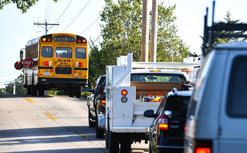 In this file photo from Aug. 23, 2021, vehicles are seen waiting behind a school bus as the driver stops to pick up students on Idlewood Road in Jefferson City. (Julie Smith/News Tribune photo)