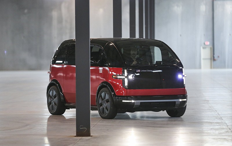 A Canoo Lifestyles vehicle takes sharp turns around building poles at the Canoo car manufacturing plant in Bentonville on Friday, May 20, 2022. Canoo, the electric car maker planning on headquartering in Bentonville, showed off its new Lifestyles vehicle in Bentonville. (NWA Democrat-Gazette/Charlie Kaijo)