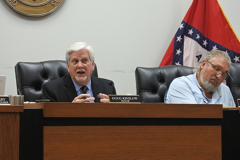 Greenwood Mayor Doug Kinslow, left, speaks while Michael Hamby, city attorney, right, listens during the Greenwood City Council meeting Monday. 
(NWA Democrat-Gazette/Thomas Saccente)