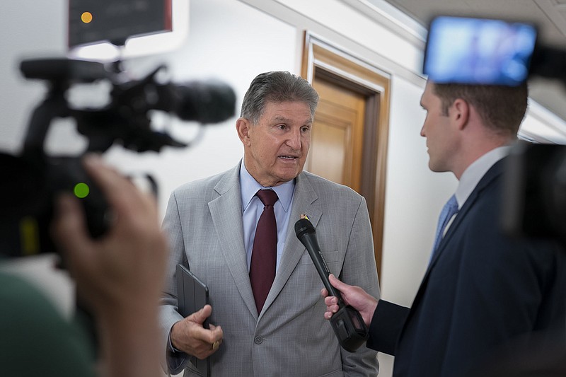 Sen. Joe Manchin talks to reporters at the Capitol on June 14. Manchin, a crucial Senate swing vote for Democrats, asserted that he would be “very, very cautious” about extending tax credits to help low- and middle-income Americans buy health insurance.
(AP/J. Scott Applewhite)