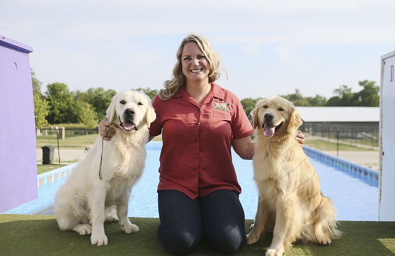 Marissa Hendrix poses for a portrait with her golden retrievers, Saturday, July 16, 2022 at Coolwag in Bentonville. Marissa Hendrix founded the Natural State Golden Retriever Club, the first accredited club of its kind in Arkansas. She hosted a Dock Diving splash day at Coolwag in Bentonville on Saturday. Visit nwaonline.com/220717Daily/ for today's photo gallery.

(NWA Democrat-Gazette/Charlie Kaijo)
