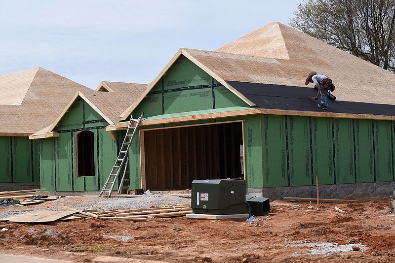 Dozens of homes are under construction at Park View subdivision in Lowell, seen March 30 2021, being built by Riverwood Homes. (NWA Democrat-Gazette/Flip Putthoff)