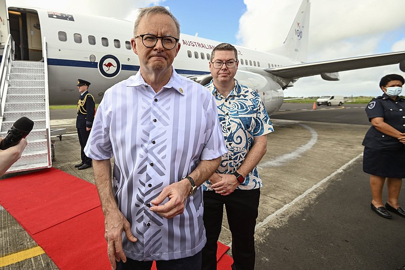 Australian Prime Minister Anthony Albanese, left, is met Pat Conroy, Australia's Minister for Defense Industry as he arrives in, Suva, Fiji, Wednesday, July 13, 2022. Albanese is attending the Pacific Islands Forum meeting as China vies for more influence in the Indo-Pacific region. (Joe Armao/Pool Photo via AP)