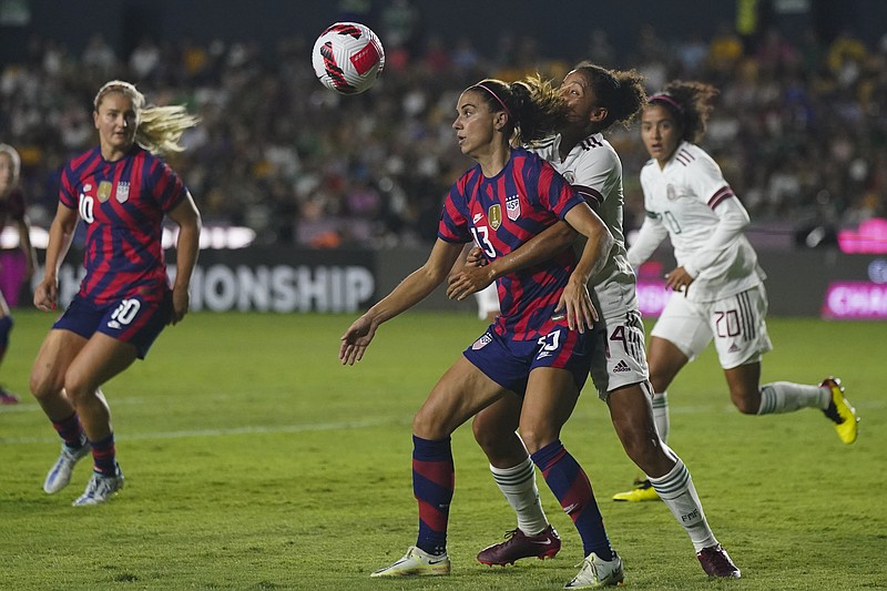 United States' Alex Morgan (13) and Mexico's Casandra Montero fight for the ball during a CONCACAF Women's Championship match July 11 in Monterrey, Mexico. - Photo by Fernando Llano of The Associated Press