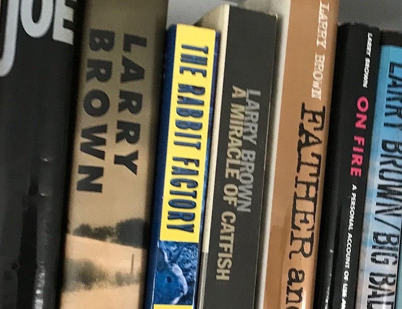 Books by Larry Brown adorn a shelf. (Arkansas Democrat-Gazette/Philip Martin)