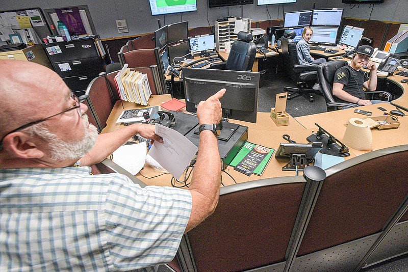 Hobe Runion (left), Sebastian County Sheriff, visits with 911 communicators Heather Pagel and Drew Dooly on Friday, July 22, 2022, inside the dispatch center at the Sebastian County Sheriffâ€™s Office in Fort Smith. The Sebastian County Quorum Court on Tuesday unanimously approved allocating $5.25 million in American Rescue Plan funds to improve the countyâ€™s emergency communications radio system, a project that will include building two new Arkansas Wireless Information Network towers in the county. Visit nwaonline.com/220724Daily/ for today's photo gallery.
(NWA Democrat-Gazette/Hank Layton)