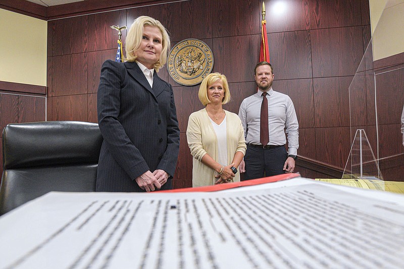 Wendy Sharum (from left), Amy Grimes and Sam Terry, Sebastian County District Court judges, stand on Friday, July 22, 2022, inside a courtroom at the Sebastian County Courts Building in Fort Smith. The court, along with the Sebastian County Circuit Court and Greenwood District Court, have all experienced reductions in failure to appear events following the implementation of the eCourtDate text notification system, which notifies defendants via text message of their upcoming court dates. Visit nwaonline.com/220724Daily/ for today's photo gallery.
(NWA Democrat-Gazette/Hank Layton)