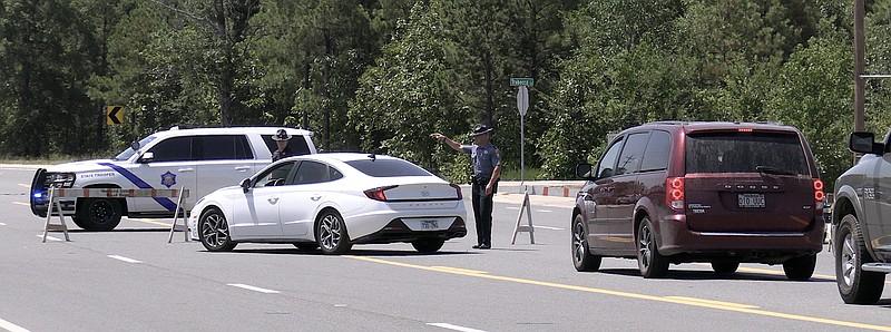 An Arkansas State Trooper directs traffic on Highway 7 south near the Highway 290 intersection on Tuesday due a natural gas leak. - Photo by Donald Cross of The Sentinel-Record