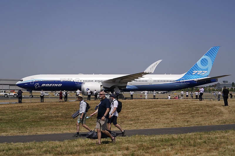 A Boeing 777X is brought on the runway ahead of a display flight, at the Farnborough Air Show fair in Farnborough, England, Tuesday, July 19, 2022. Some 1191 exhibitors from around the world show their newest developments in Future Flight, Space, Defence, Innovation, Sustainability and Workforce from July 18th until July 22, 2022.(AP Photo/Alberto Pezzali)