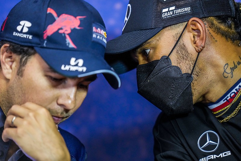 Mercedes driver Lewis Hamilton of Britain, right, talks with Red Bull driver Sergio Perez of Mexico during a press conference ahead of the French Formula One Grand Prix at the Paul Ricard racetrack in Le Castellet, southern France, Thursday. - Photo by Manu Fernandez of The Associated Press