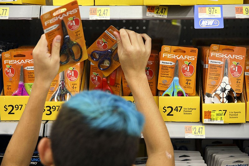 A child browses school supplies at a Walmart. (Bloomberg photo by Patrick T. Fallon)