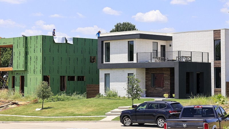 A New Modern Home is under construction alongside a completed home in Frisco, Texas, Friday, July 15, 2022. (Elias Valverde II/The Dallas Morning News/TNS)
