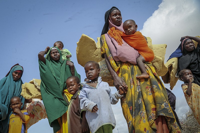 FILE - Somalis who fled drought-stricken areas carry their belongings as they arrive at a makeshift camp for the displaced on the outskirts of Mogadishu, Somalia, on June 30, 2022. Food prices accounted for about 60% of last year’s increase in headline inflation in the Middle East and North Africa, with the exception of oil-producing Gulf countries. In Somalia, where 2.7 million people cannot meet their daily food requirements and where children are dying of famine, sugar is a source of energy and fuel. In May, a kilogram (2.2 pounds) of sugar cost around the equivalent of 72 cents in the capital, Mogadishu. (AP Photo/Farah Abdi Warsameh, File)