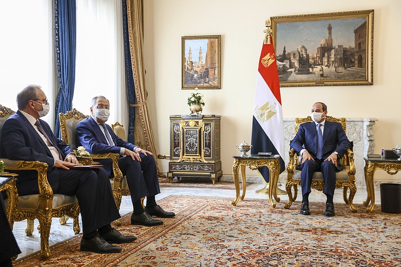 In this handout photo released by Russian Foreign Ministry Press Service, Russian Foreign Minister Sergey Lavrov, second left, and Egyptian President Abdel-Fattah el-Sissi, right, attend talks in Cairo, Egypt, Sunday, July 24, 2022. (Russian Foreign Ministry Press Service via AP)