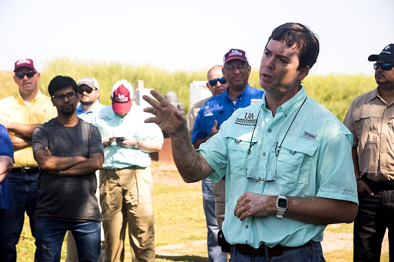 Chris Henry discusses irrigation management and safety. Visitors toured test plots and heard presentations about Division of Agriculture research during a field day Aug. 3, 2018, at the Rice Research and Extension Center. (Special to The Commercial/Fred Miller/University of Arkansas System Division of Agriculture)