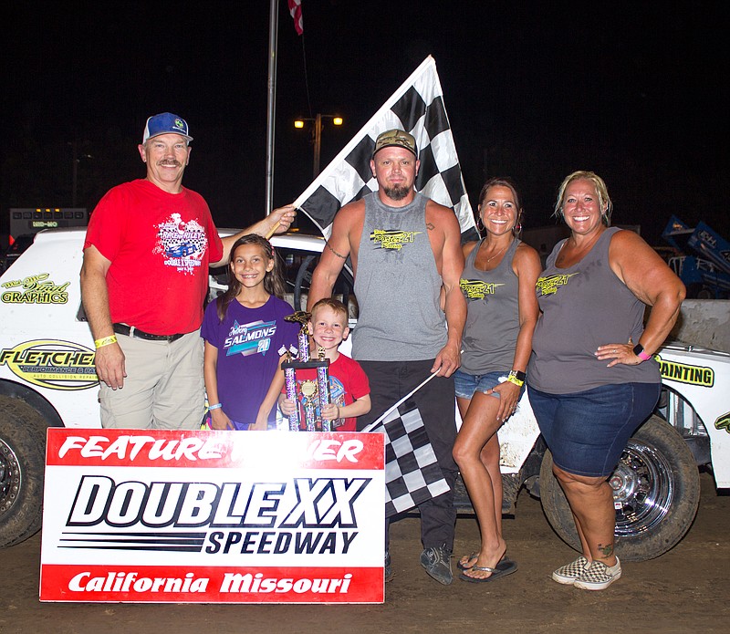 Darin Porter claimed the pure stock feature trophy Sunday night at Double-X Speedway.  Porter is pictured with his fiance, Leslie Turpin, and her sister, Tara Turpin, all of California.  Director of competition Brad Friedmeyer assists as Brooklynn and Willy Utz present the trophy. (Submitted photo)