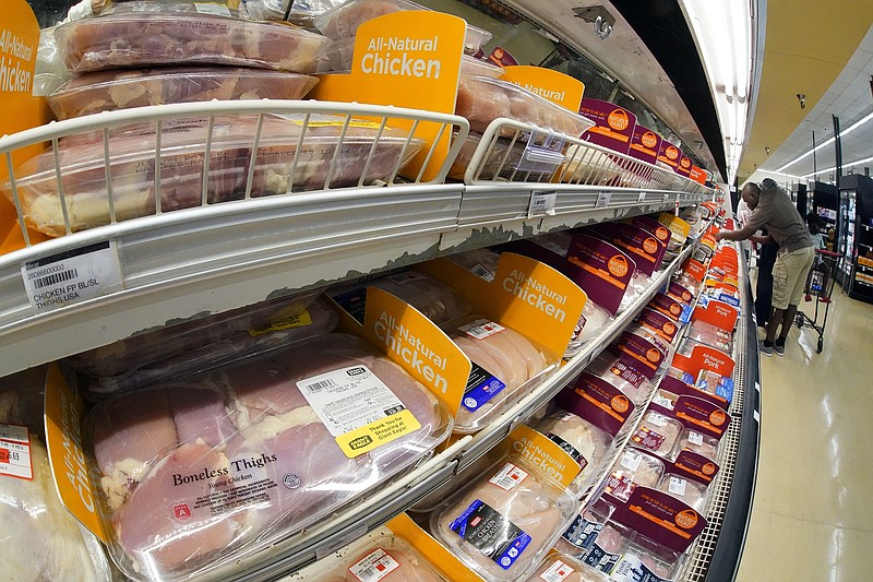 FILE - Chicken is on display in a market in Pittsburgh, July 12, 2022. The Justice Department is expected to file a lawsuit and proposed settlement against some of the largest poultry producers in the U.S. It's part of an effort to end what the government claims have been longstanding deceptive and abusive practices for workers. (AP Photo/Gene J. Puskar, File)