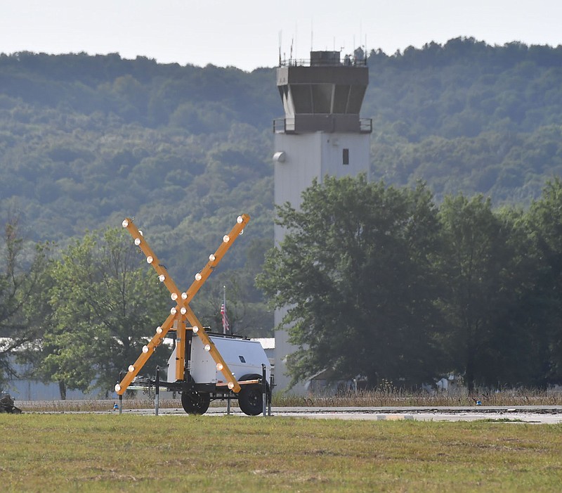 A lighted X stands Monday, July 25, 2022, at the northern end of the airfield as work continues to remove the surface of the runway at the Fayetteville Executive Airport. The project to resurface the runway and improve drainage, lighting and markings is expected to be complete by Aug. 8. Visit nwaonline.com/220726Daily/ for today's photo gallery. 
(NWA Democrat-Gazette/Andy Shupe)