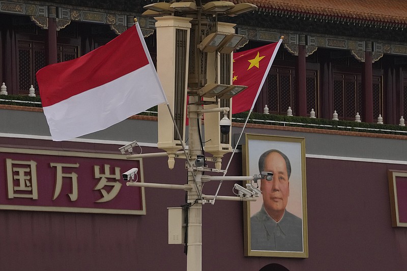 The Indonesian and Chinese national flags are flown together near Mao Zedong's portrait on Tiananmen Gate in Beijing, Monday, July 25, 2022. Indonesian President Joko Widodo was heading to Beijing on Monday for a rare visit by a foreign leader under China's strict COVID-19 protocols and ahead of what could be the first overseas trip by Chinese President Xi Jinping since the start of the pandemic more than two years ago. (AP Photo/Ng Han Guan)