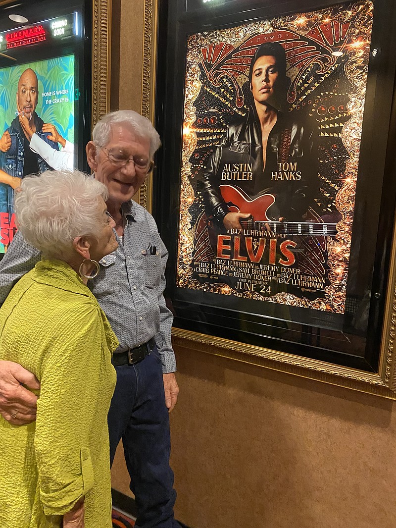 Doolie Jones and her boyfriend John Hall admire an Elvis poster. (photo by Becky Bell)
