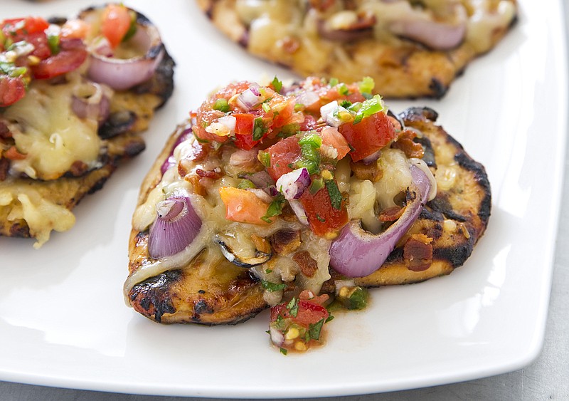 Grilled Monterey Chicken shown here topped with diced tomatoes. (Courtesy of America’s Test Kitchen)