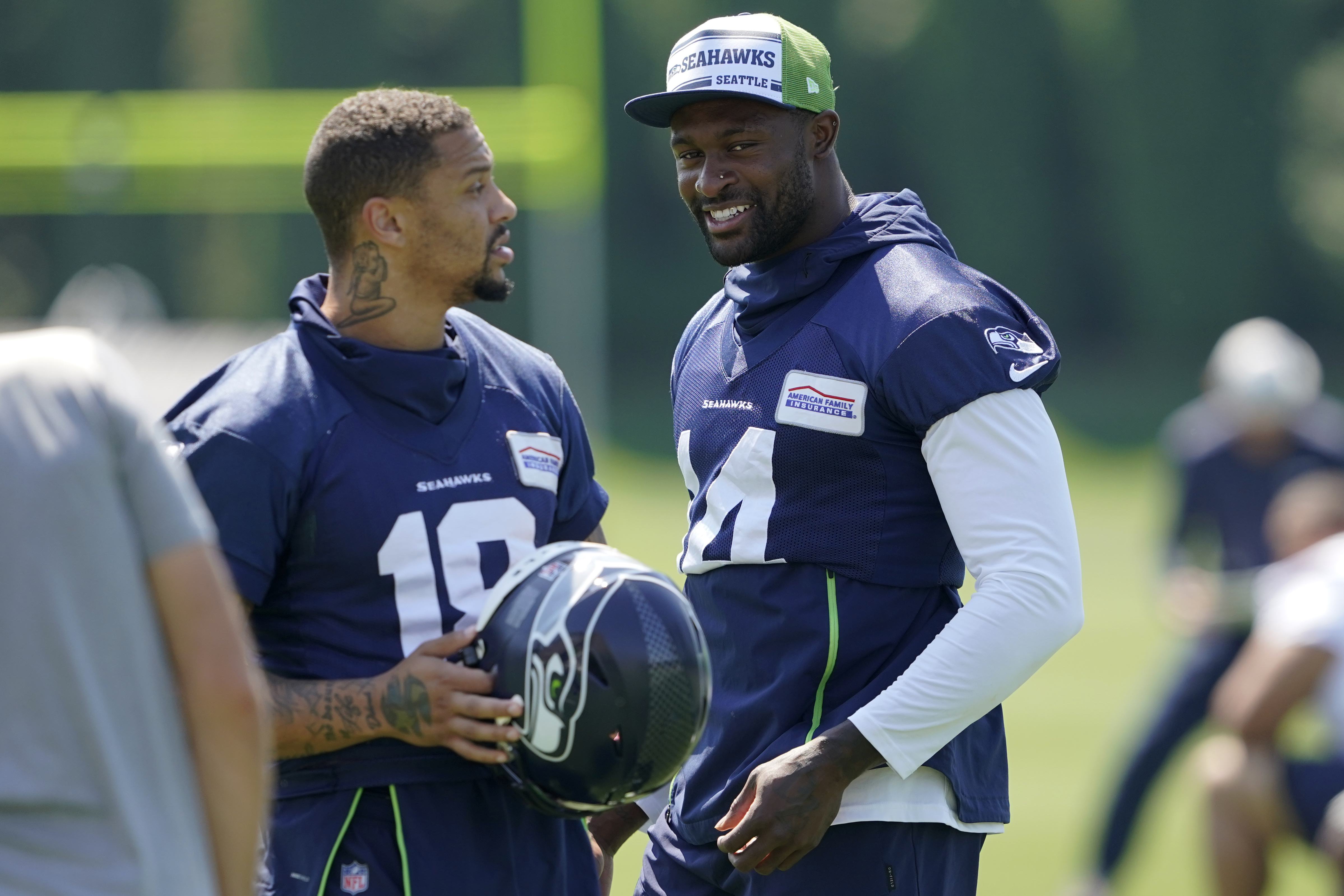 Larry Wales, of Seattle, wears the #14 jersey of Seattle Seahawks wide  receiver DK Metcalf as well as Metcalf's trademark pacifier mouth guard as  he arrives to watch NFL football practice, Wednesday