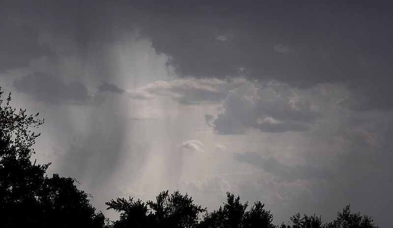 Westside Eagle Observer/MIKE ECKELS Looking west from Decatur City Hall, several rain shafts fall from the southern boundary of a building thunderstorm on July 27 as a frontal system stalls over Northwest Arkansas, bringing with it much-needed rain. The shafts moved through the Gentry area and on toward Springdale and Rogers.