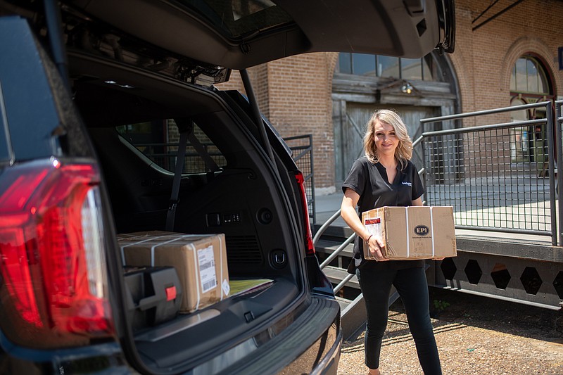 On behalf of the Greater Texarkana Young Professionals, Natalie Copeland loads school supplies to be delivered to Texarkana Resource for their Stuff the Bus program on Friday, Aug. 5, 2022 in Texarkana. (Staff photo by Erin DeBlanc)