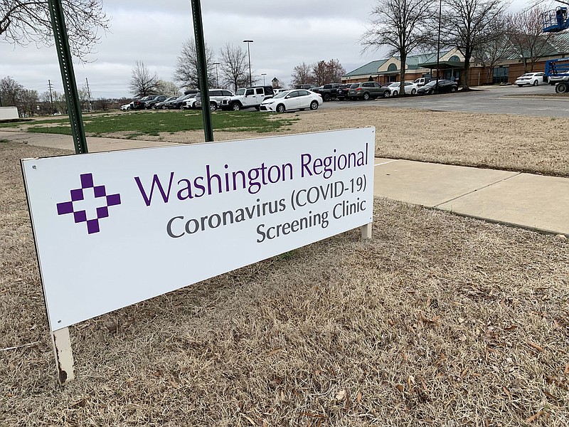 A sign stands to mark the entrance of a screening clinic operated by Washington Regional Medical Center at 3318 N. Northhills Blvd. in Fayetteville. (NWA Democrat-Gazette/Andy Shupe)