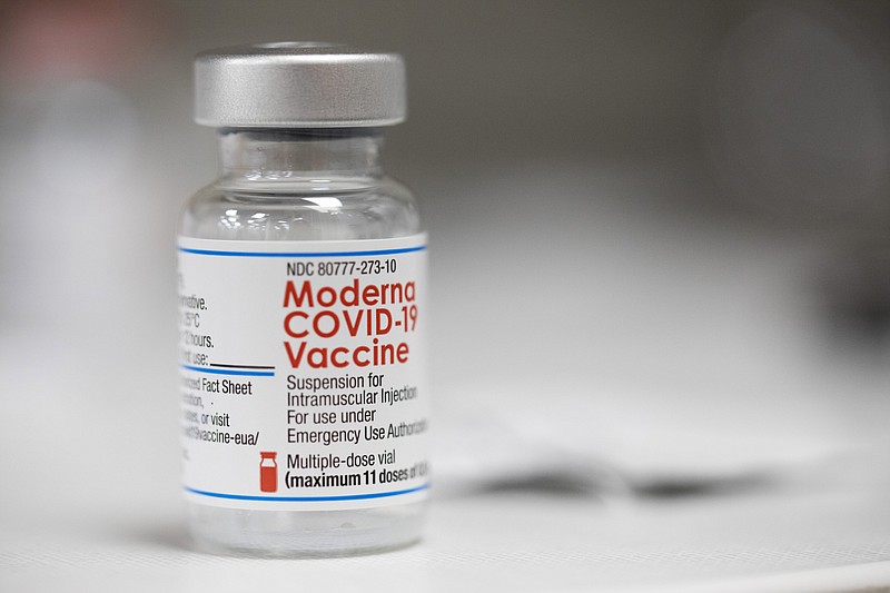 FILE - A vial of the Moderna COVID-19 vaccine is displayed on a counter at a pharmacy in Portland, Ore. on Dec. 27, 2021. The Biden administration said Friday it has reached an agreement to buy 66 million doses of Moderna&#x2019;s next generation of COVID-19 vaccine that specifically targets the highly transmissible omicron variant, ensuring enough supply this winter for everyone who wants the upgraded booster. (AP Photo/Jenny Kane, File)