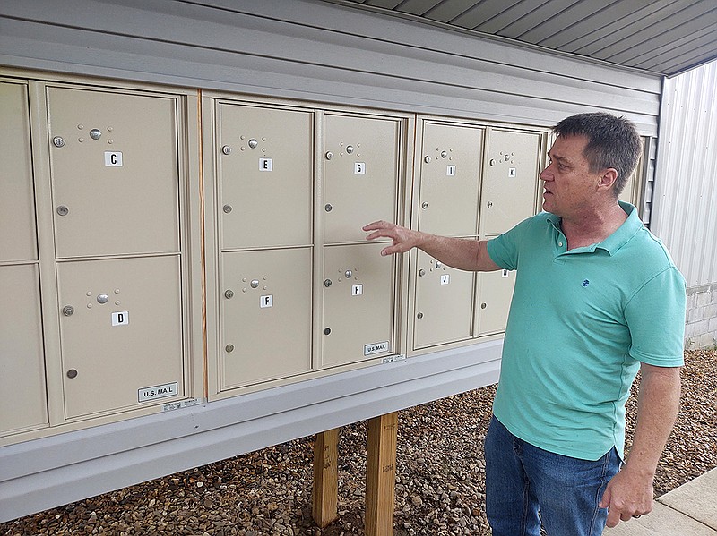 Fred Teague, director of housing and homeless prevention initiatives for the 1 Roof organization in Russellville, inspects mailboxes set up for the organization’s homeless clients. (Arkansas Democrat-Gazette/Jeannie Roberts)