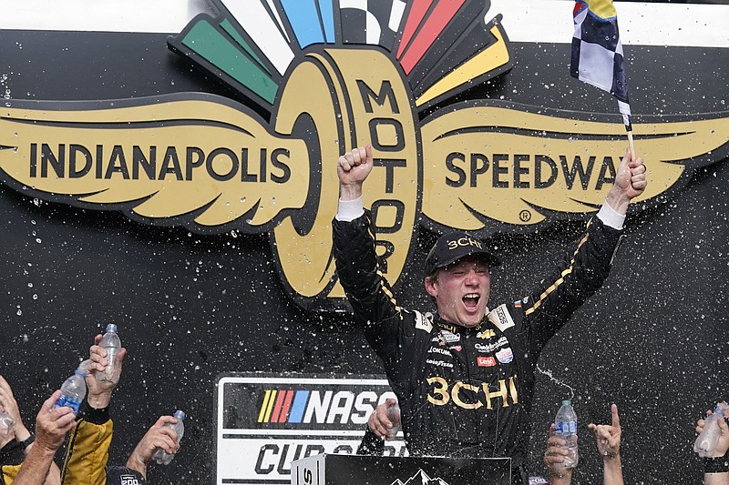 Tyler Reddick celebrates after winning a NASCAR Cup Series auto race at Indianapolis Motor Speedway, Sunday, July 31, 2022, in Indianapolis. (AP Photo/Darron Cummings)