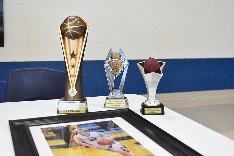 Trophies for the second Hoopin' for Lucas 3-on-3 basketball tournament overlook a photo of Lucas Oswald, the honoree of the memorial tournament and a former California Pintos basketball player who died last year from natural causes. The tournament was held at 9 a.m. Saturday (July 30, 2022,) at California High School. (Democrat photo/Garrett Fuller)