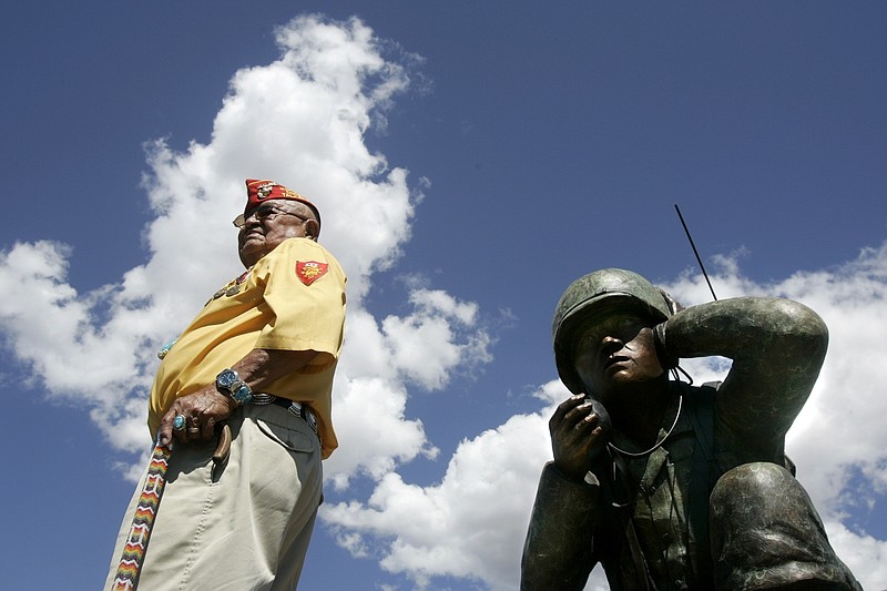 FILE - In this Sept. 8, 2004, photo, Navajo Code Talker Samuel Sandoval of Shiprock, N.M., poses for pictures during a ceremony where the Oreland C. Joe Code Talker sculpture was unveiled at the Navajo Nation Fairgrounds in Window Rock, Ariz. Samuel Sandoval, one of the last remaining Navajo Code Talkers who transmitted messages in World War II using a code based on their native language, has died late Friday, July 29, 2022, at a hospital in Shiprock, N.M., his wife, Malula told The Associated Press on Saturday. He was 98. (Brett Butterstein/The Daily Times via AP, File)