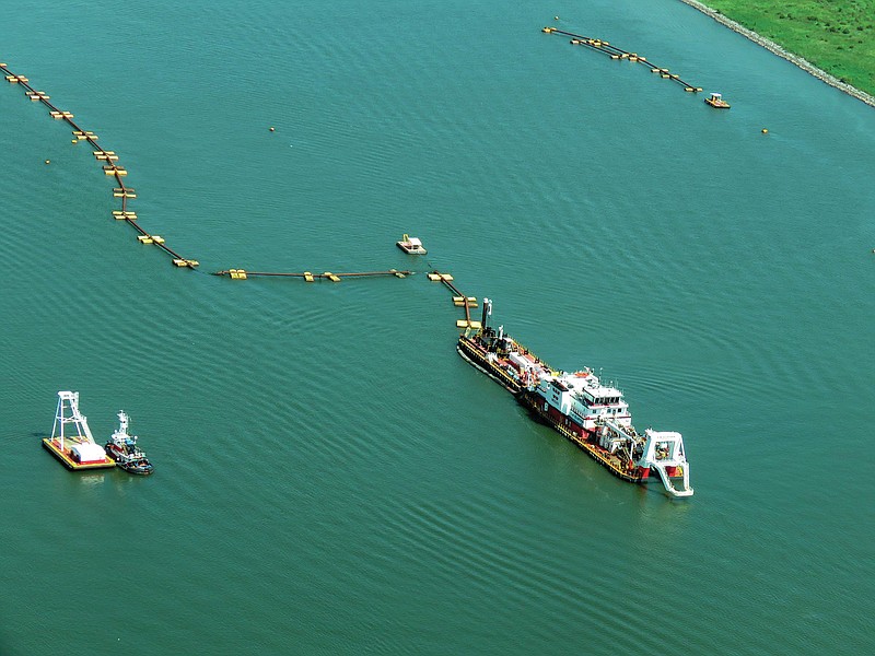 A dredge in the Mississippi River near Venice, La., pumps sediment from the bottom July 21. A pipeline carries the sediment to create 7 miles of new marshes and ridges, starting near Venice. (AP/Janet McConnaughey)