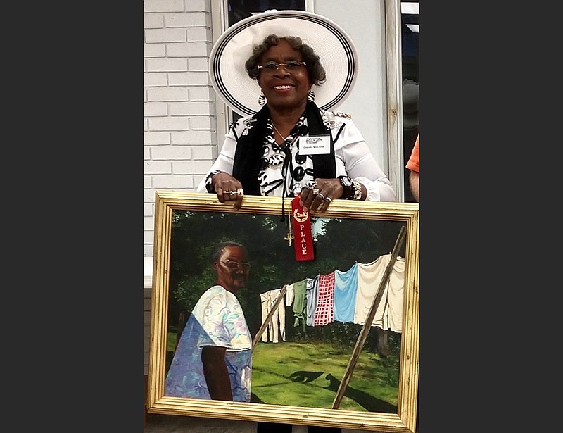 Little Rock artist Glenda McCune holds her painting "Mrs. Lucy's Wash," which is included in the National Art Education Association’s Member Exhibition. (Special to the Democrat-Gazette)