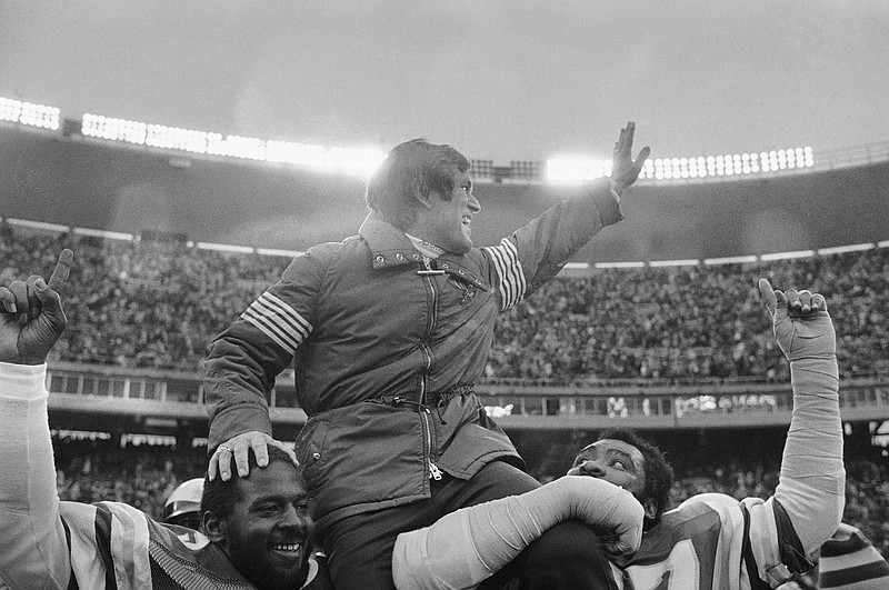 FILE - Philadelphia Eagles coach Dick Vermeil is carried from the field Jan. 3, 1981, by players Claude Humphrey, right, and Charlie Johnson, left, after the Eagles defeated the Minnesota Vikings 31-16 in Philadelphia to advance in the NFL playoffs. Vermeil won a Super Bowl with the St. Louis Rams and later coached the Kansas City Chiefs. But Philly is home and he’s going into the Pro Football Hall of Fame as an Eagle. (AP Photo/Clem Murray, File)