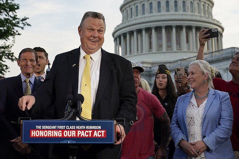 Sen. Jon Tester, D-Mont., speaks at a news conference alongside Sen. Richard Blumenthal, D-Conn., back left, and Sen. Kirsten Gillibrand, D-N.Y., after the Senate passed a bill designed to help millions of veterans exposed to toxic substances during their military service, Tuesday, Aug. 2, 2022, on Capitol Hill in Washington. (AP Photo/Patrick Semansky)