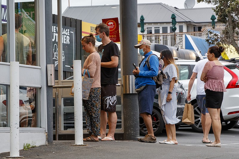 Shoppers rush and queue to enter the supermarket before the alert level change on February 14, 2021 in Auckland, New Zealand. New Zealand will fully reopen its border to the world on Sunday after closing to almost all travelers in March 2020 toward the beginning of the pandemic. (Dave Rowland/Getty Images/TNS)
