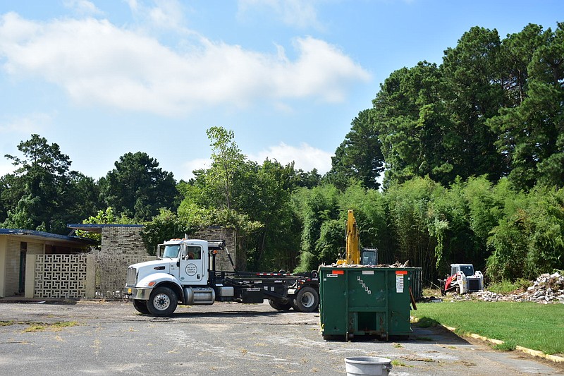 The westernmost building of the former Admiral Benbow Inn on East Harding Avenue in Pine Bluff is demolished and small trees cleared Wednesday. (Pine Bluff Commercial/I.C. Murrell)