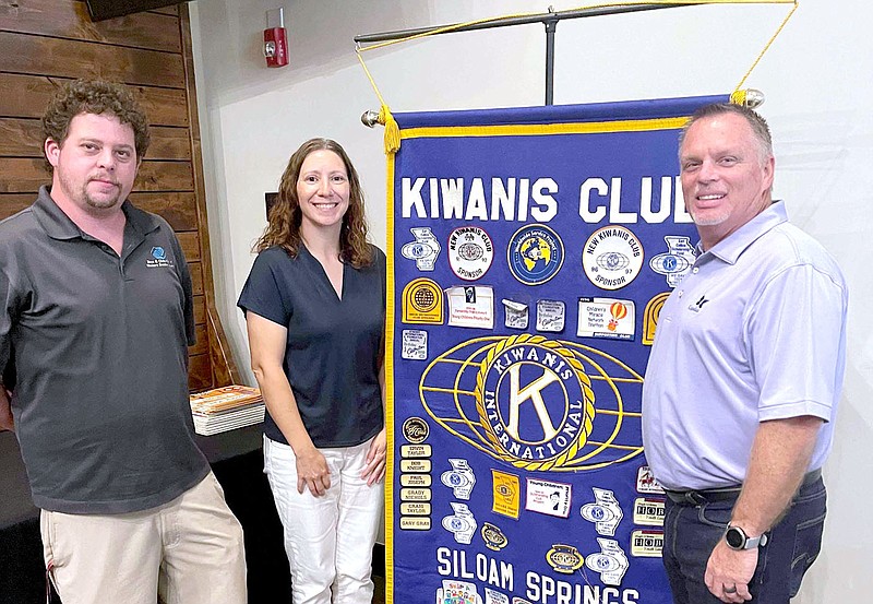 Photo Submitted Tiffany Hansen (center) the coordinator of Bright Futures poses with Kiwanis Club President Stephen Johnston and Gary Wheat program sponsor. Hansen spoke about Bright Futures during the meeting on Aug. 3 as well as the backpack program where volunteers hand out pre-packed backpacks to families who cannot afford school supplies.