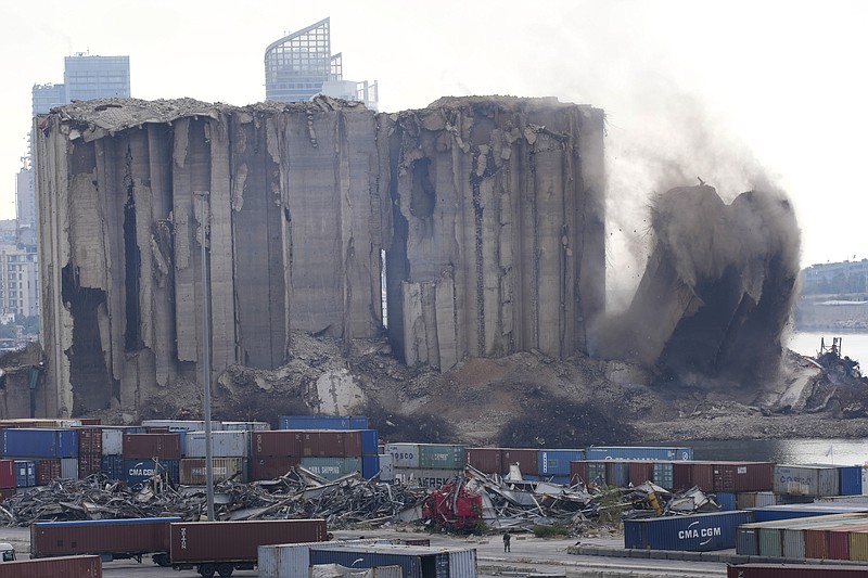 A left part of the silos damaged during the August 2020 massive explosion in the port is seen collapsing Thursday, Aug. 4, 2022, in Beirut, Lebanon. (AP Photo/Hussein Malla)