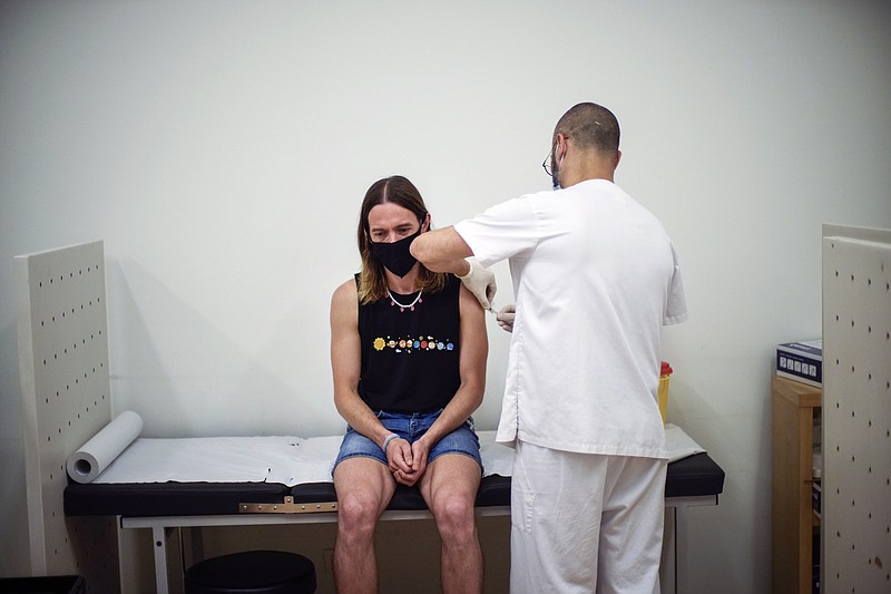 Daniel Rofin, 41, receives a vaccine against Monkeypox from a health professional in medical center in Barcelona, Spain, July 26, 2022. The U.S. will declare a public health emergency to bolster the federal response to the outbreak of monkeypox that already has infected more than 6,600 Americans. That's according to two people familiar with the matter said. (AP Photo/Francisco Seco, File)