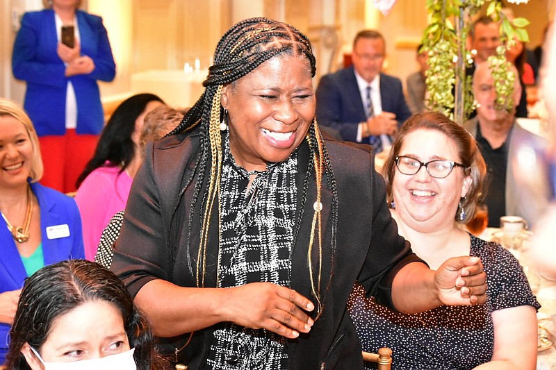 Dollarway High School math teacher Elouise Shorter smiles and walks back to the stage after being announced as a semifinalist for 2023 Arkansas Teacher of The Year on Thursday at the Governor's Mansion in Little Rock. (Pine Bluff Commercial/I.C. Murrell)
